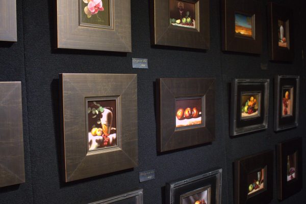 A wall of oil paintings by George Ceffalio are for sale at the Main Street Arts Festival in Fort Worth on Friday. The festival, which was attended by Coppell High School AP art students on a two-part field trip, hosts artists and art lovers from across the United States.
