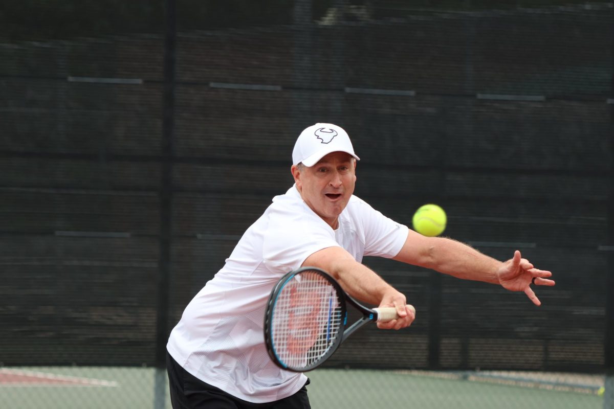 Coppell chemistry teacher Chris Stricker hits a forehand in his doubles match during the Coppell tennis player and faculty tournament at the CHS Tennis Center on April 19. Chemistry teacher Chris Stricker and sophomore Lexie Patton won the tournament.
