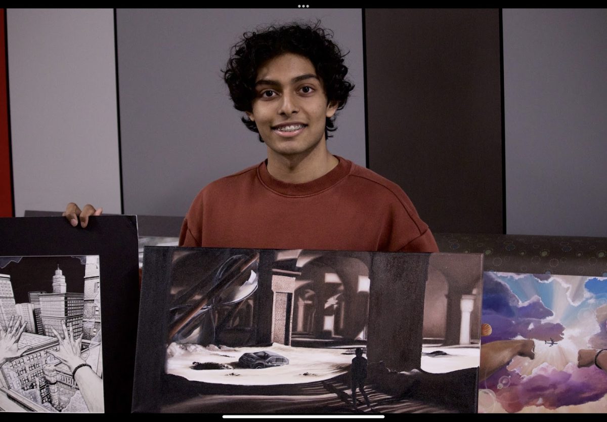 Coppell High School junior Ayan Dadsena holds up three of his art pieces. Dadsena has been a passionate artist since childhood, and details his artwork on his Instagram and through a digital portfolio on Bulb. (EV Kennard)