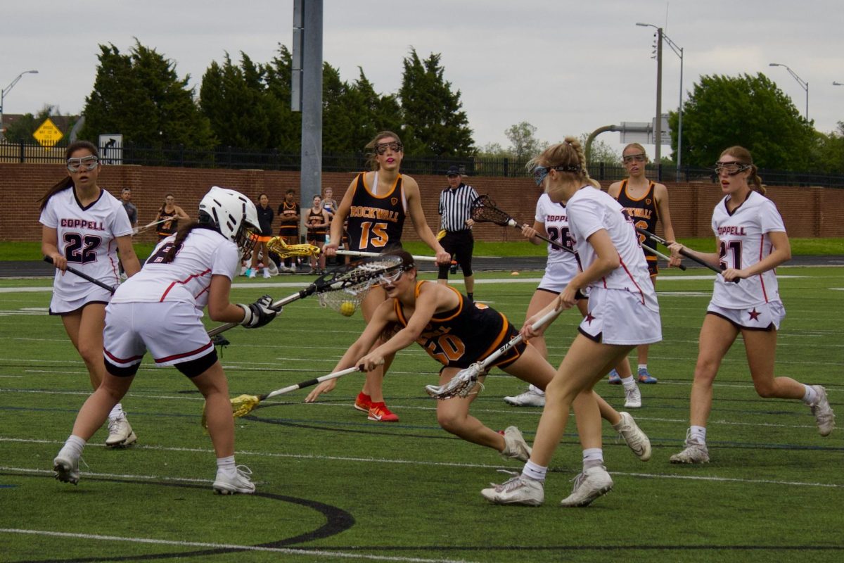 Rockwall senior Ellie Graves fights for possession against Coppell senior Olivia Garcia on Saturday at Coppell Middle School North. Rockwall defeated Coppell, 23 - 9.