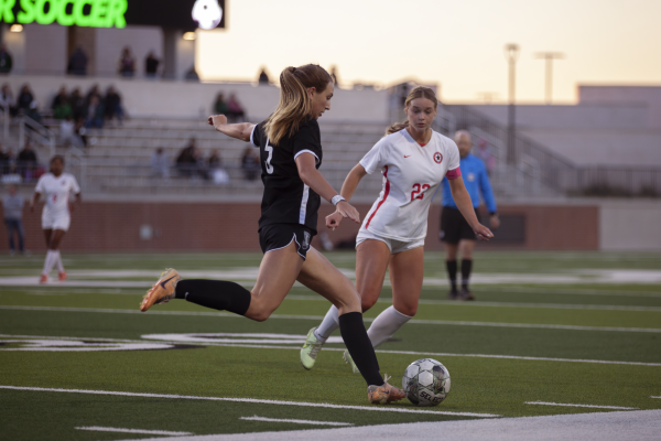 Coppell senior forward Sadie Ozymy defends Prosper sophomore defender Rhiannon Mahon at Prosper ISD Children’s Health Stadium on March 26. The Eagles defeated the Cowgirls, 2-1, in the Class 6A Region I bi-district playoffs during the second overtime period. 
