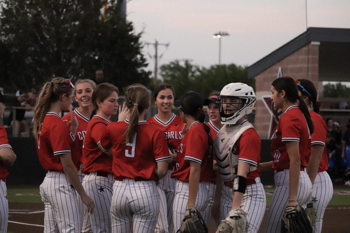The Coppell softball team celebrates a run scored in the first inning against Plano West on Friday at the Coppell ISD Baseball/Softball Complex. The Panthers defeated the Cowgirls, 8-1.