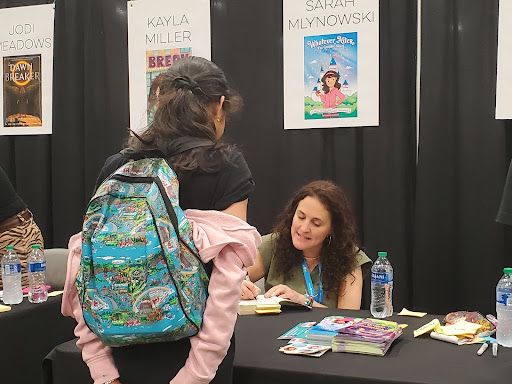 Author Sarah Mlynowski signs a book for attendees of North Texas Teen book festival.  The festival brings readers and authors together and was held at the Irving Convention Center on April 27. 