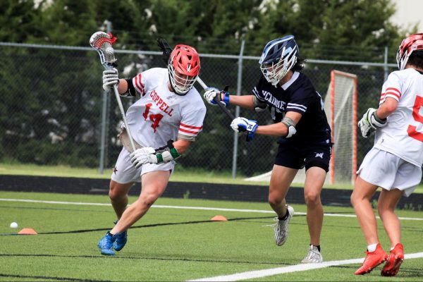 Coppell junior midfielder Edward Griffin sprints past McKinney sophomore defense Jake Hatch on Saturday at Lesley Field for the Class A Super Regionals. The Cowboys defeated the Lions, 8-7.