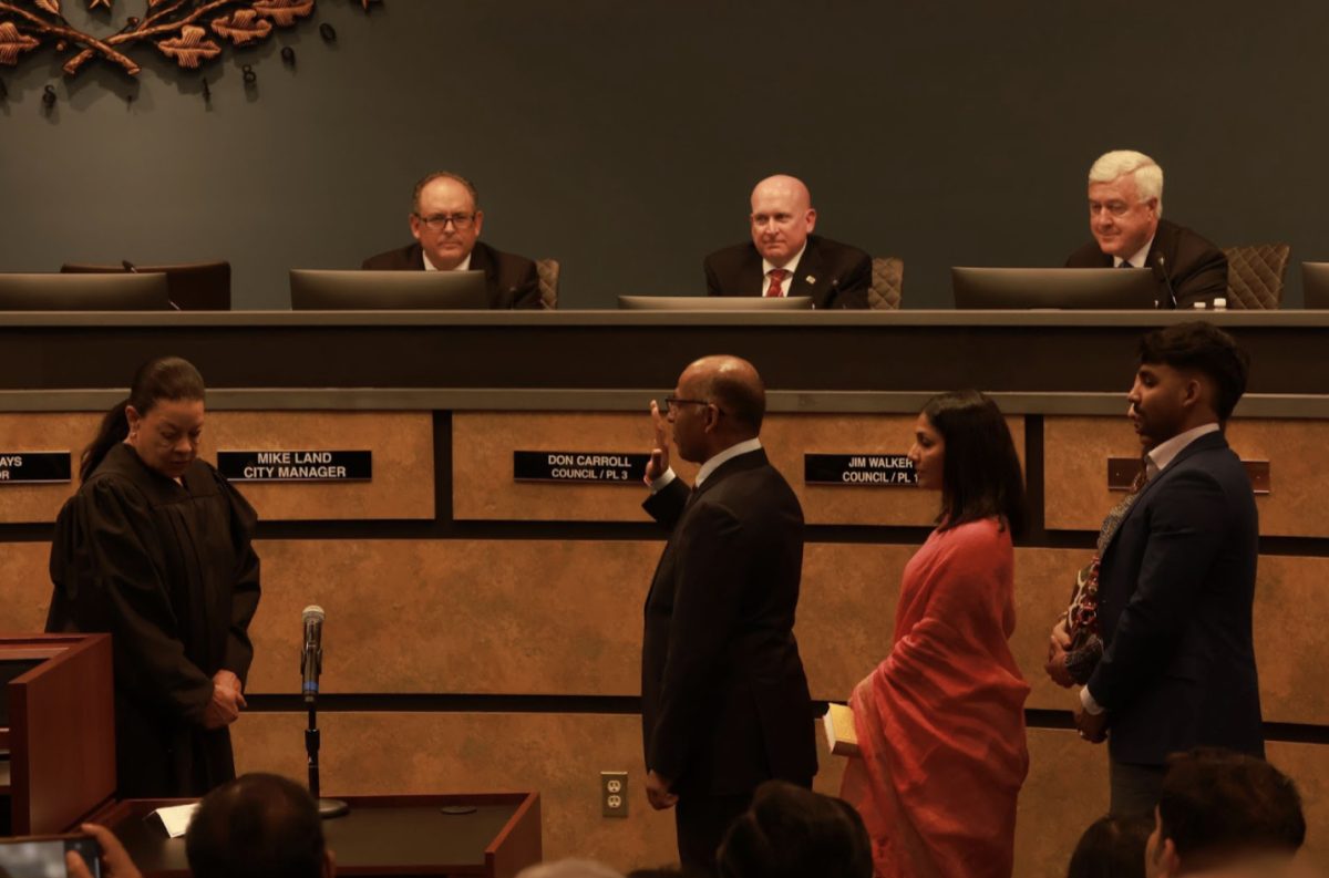 Newly elected Ramesh Premkumar stands with his family as he gets sworn in for Place 5 at the Coppell City Council Meeting on Tuesday. The council swore in the mayor and Places 4, 5 and 6, and approved the zoning plans of new buildings at Coppell High School. 
