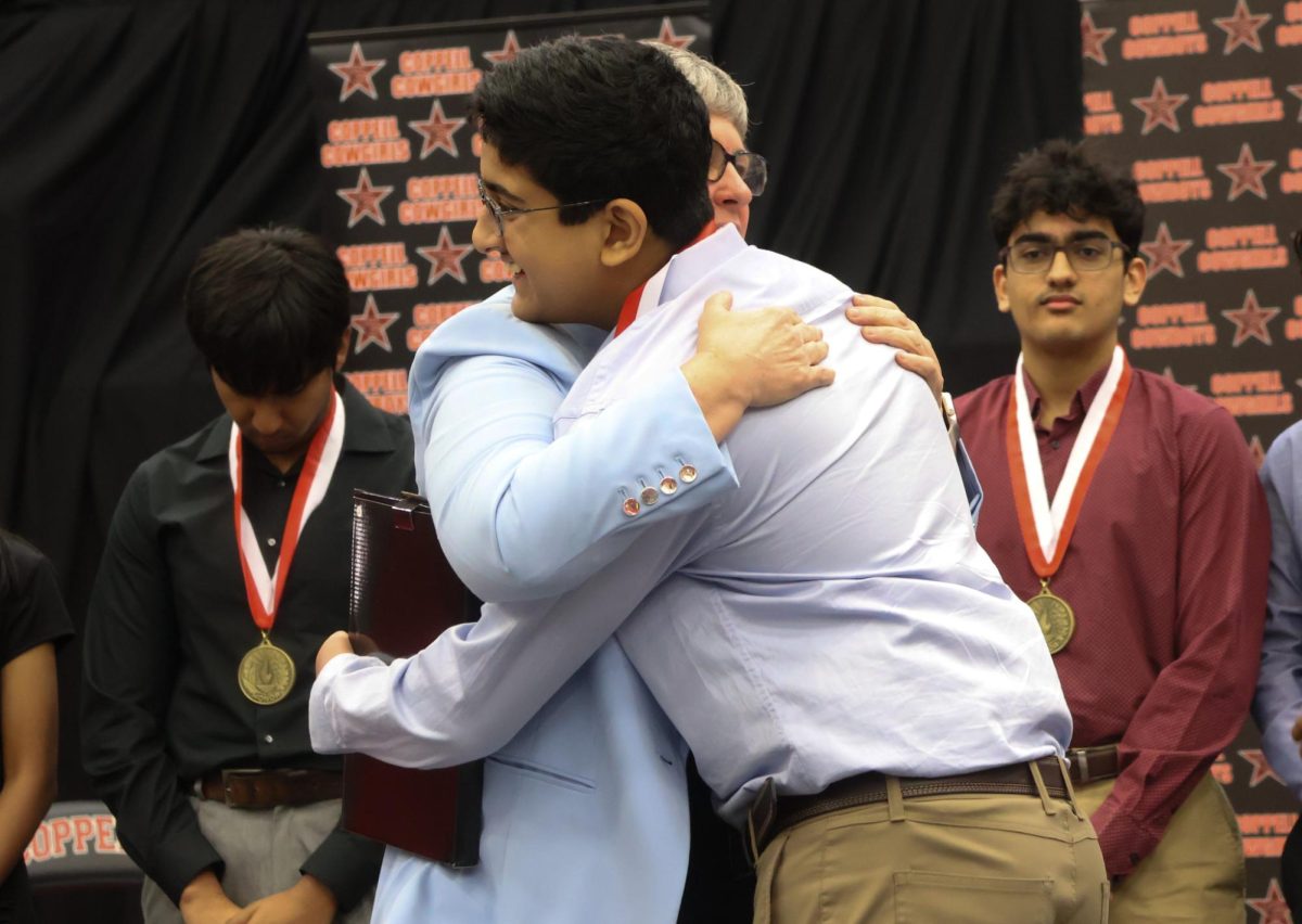 Coppell High School Principal Laura Springer congratulates senior valedictorian Vishnu Marella for graduating first in his class during the senior award ceremony on Tuesday at CHS Arena. Every year, invited seniors are presented with senior awards by CHS staff and faculty to commemorate their work throughout the year.
