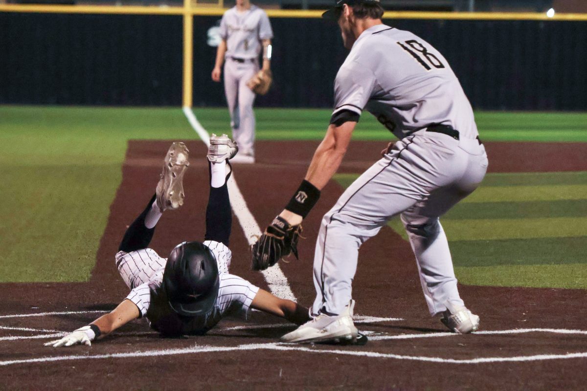 Coppell senior second base Salvador Alonzo slides safely to home plate during the sixth inning against Plano East at the Coppell ISD Baseball/Softball Complex on April 26. The Cowboys defeated the Panthers, 6-1, in the final district game.