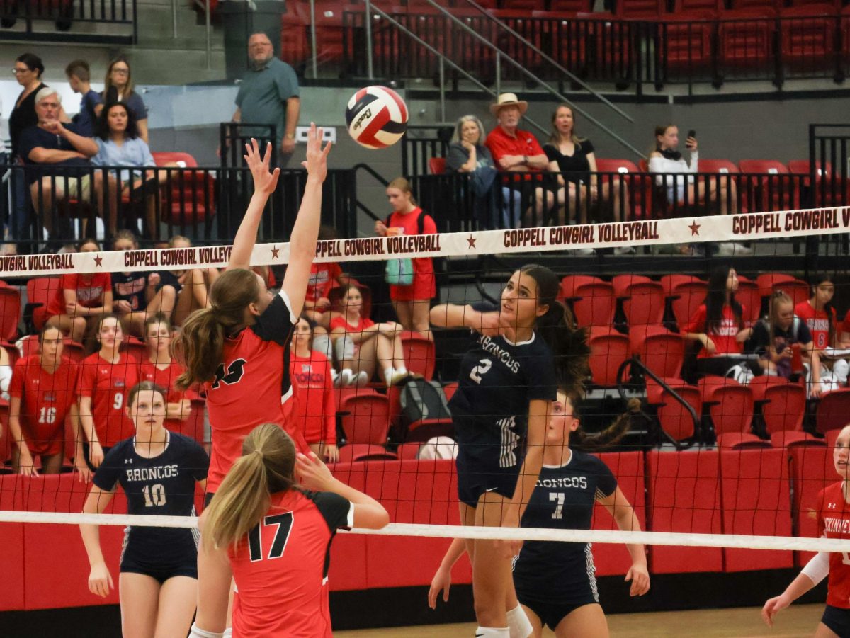 Coppell sophomore middle hitter Finley Penniman blocks against Mckinney Boyd junior middle hitter Keira Bose at CHS Arena on Tuesday. The Cowgirls lost to the Broncos, 3-1 (22-25, 25-19, 27-25, 25-23) after a back and forth match during each set. 