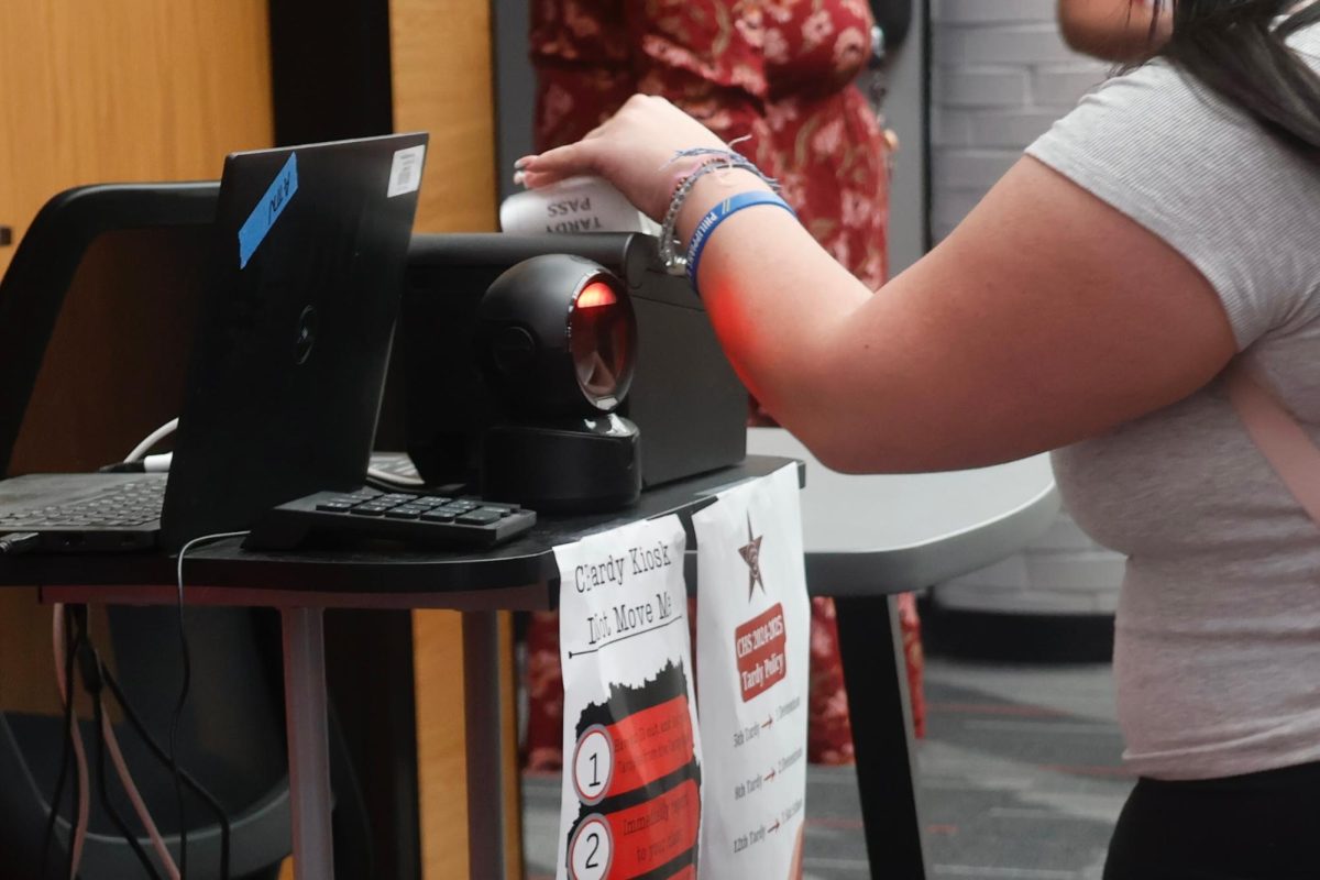 A Coppell High School student scans ID at a tardy kiosk and takes a slip to enter their classroom after 8:50 a.m. on Wednesday. The tardy system, implemented at the start of the 2024-25 school year in CHS, New Tech High @ Coppell and CHS9, aims to reduce the number of late student arrivals to classes. 