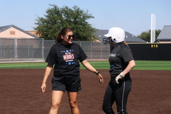 Coppell softball coach and CISD girls athletic coordinator Emily Witt talks to Coppell senior catcher Kimber Kerrigan during practice on Sept. 10 at Coppell ISD Baseball/Softball Complex. Witt served as head softball coach for George Ranch High School in Houston for three years prior to coming to Coppell.