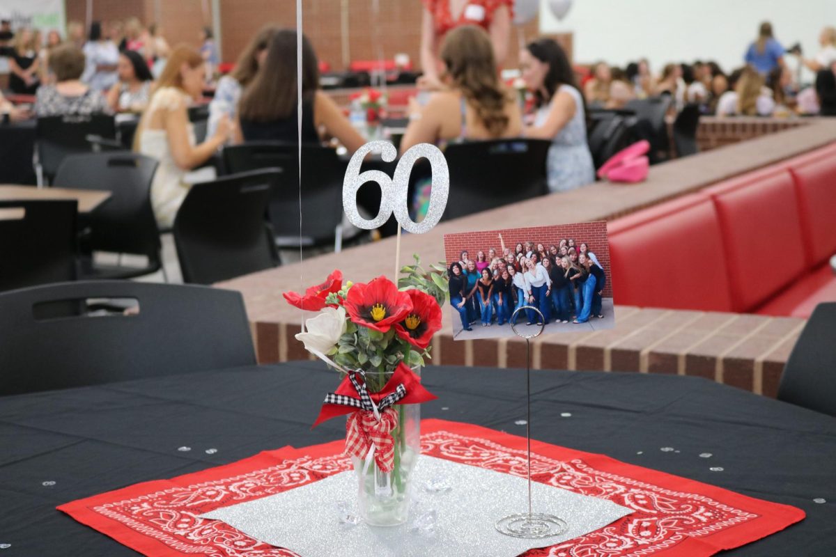 Photos of former Coppell High School Lariettes are displayed at tables during the Lariette Celebration Tea on Saturday at the CHS Commons. Current Lariettes and alumni gathered to honor their 60th anniversary.