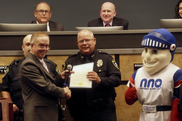 Coppell Mayor Wes Mays presents Police Chief Danny Barton with a proclamation naming National Night Out as Oct. 1 at the City Council Meeting on Tuesday. The city council approved plans to renovate the service center and a water redundancy project.