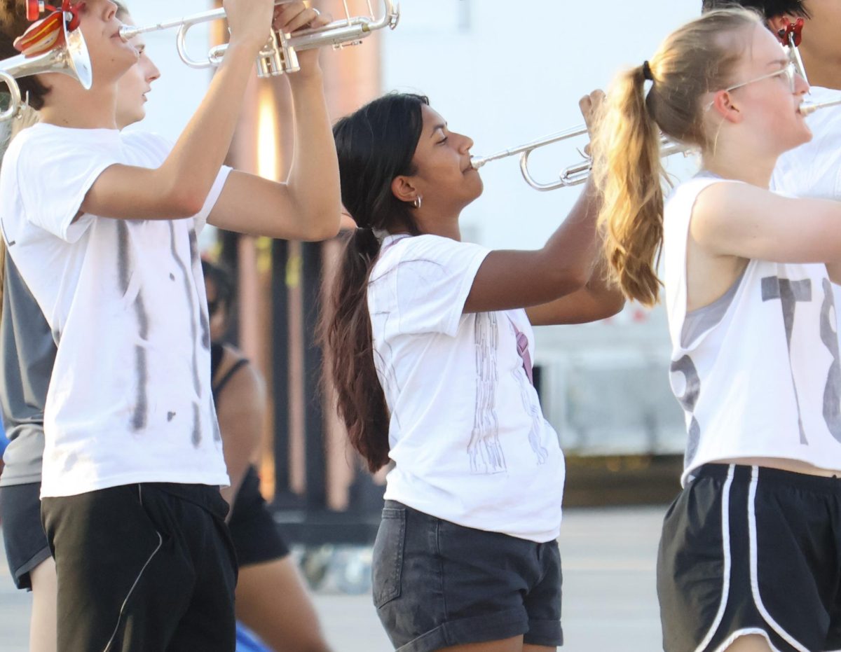 CHS9 student Manya Goyal plays the trumpet during a varsity marching band rehearsal on the band field on Sept. 17. Goyal was chosen for varsity marching band this year.