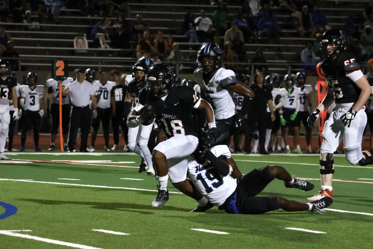 Coppell senior running back Josh Lock towards the end zone as Hebron junior defensive back Kylan Smart tails him during the Homecoming Game at Buddy Echols Field on Friday. The Cowboys defeated the Hawks, 49-14.