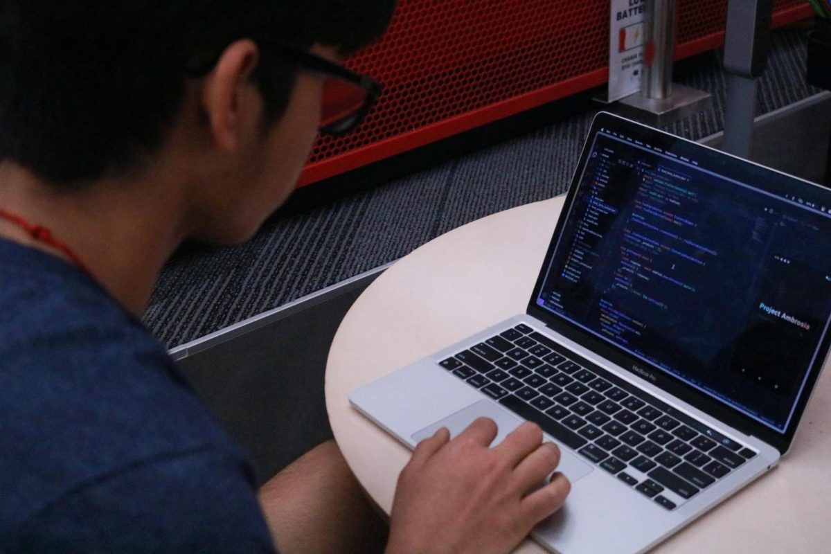 Coppell High School junior Anmol Deepak works on the code for his passion project ”Project Ambrosia” in the CHS Library on Sept 6. The Sidekick staff designer Ahana Roy thinks the competitiveness of college admissions takes the passion out of passion projects for many high school students.