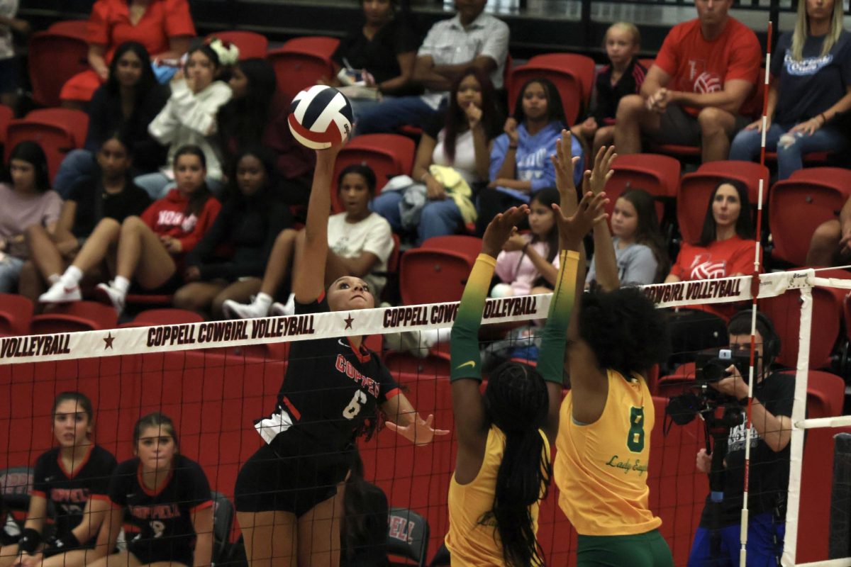 Coppell junior opposite hitter Mari Hill spikes against DeSoto at CHS Arena on Tuesday. The Cowgirls defeated the Eagles, 25-21, 18-25, 25-19, 25-19, in a close match.