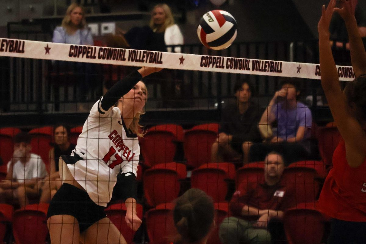 Coppell sophomore opposite hitter Brooke Felix spikes against Grapevine on Tuesday in the CHS Arena. The Cowgirls made a comeback against the Mustangs (13-25, 19-25, 25-13, 25-19, 15-10) with a suspenseful victory.