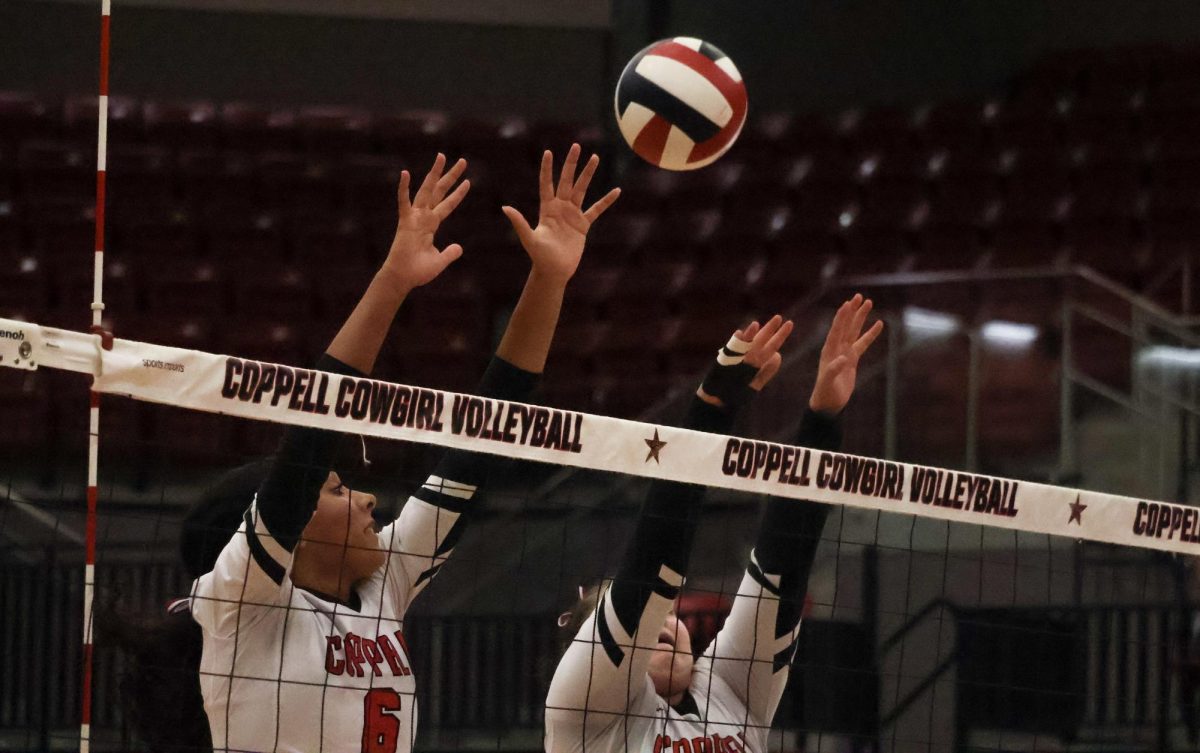 Coppell junior opposite hitter Mari Hill and junior middle blocker Katie Keith block a spike from Grapevine on Tuesday in the CHS Arena. The Cowgirls open District 5-6A play on Friday against Hebron at CHS Arena.