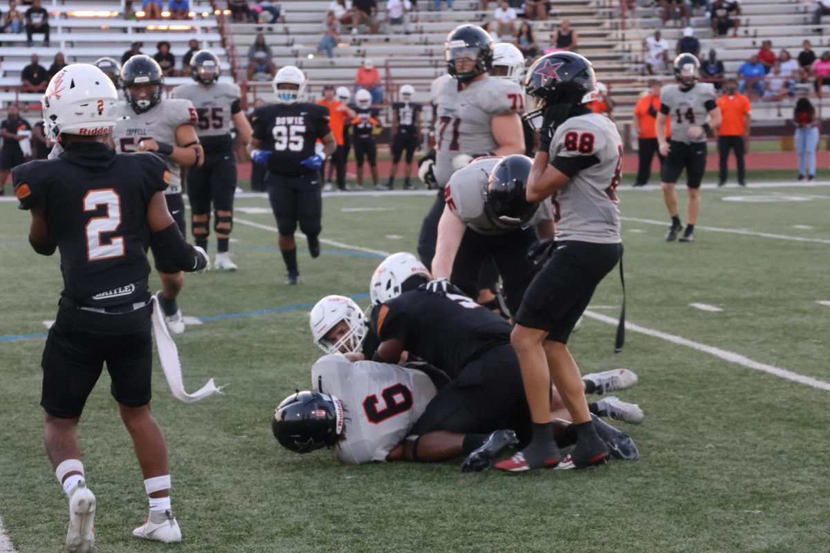 Arlington Bowie senior linebacker Jeremiah Brinson tackles Coppell senior running back O’Marion Mbakwe on Friday night at Wilemon Field. Coppell won 72-33 against the Volunteers. 