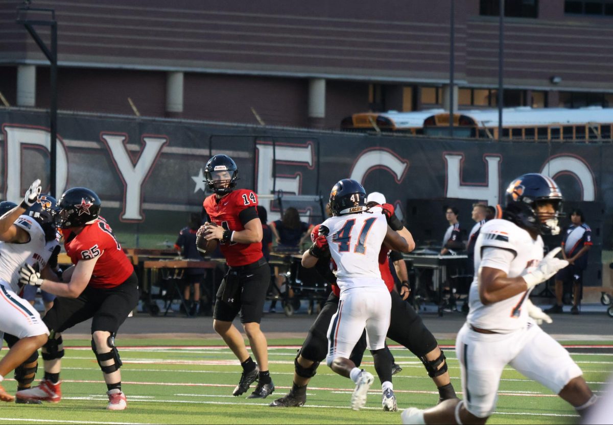 Coppell senior quarterback Edward Griffin looks for an open receiver against the Sachse defense on Aug. 30 at Buddy Echols Field. The Cowboys defeated Sachse, 31-10 as the game featured recognition for seniors in football, cheer, sports medical team and a special 60th anniversary Lariettes performance throughout the night.