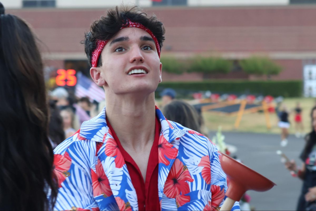 Coppell senior Plunger Boy Jake Chew interacts with the student section during the football game against Sachse on Aug. 30 at Buddy Echols Field. As Plunger Boy, Chew is in charge of increasing energy in the student section at sports games and continuing the long-standing tradition of the Coppell High School Plunger Boy.