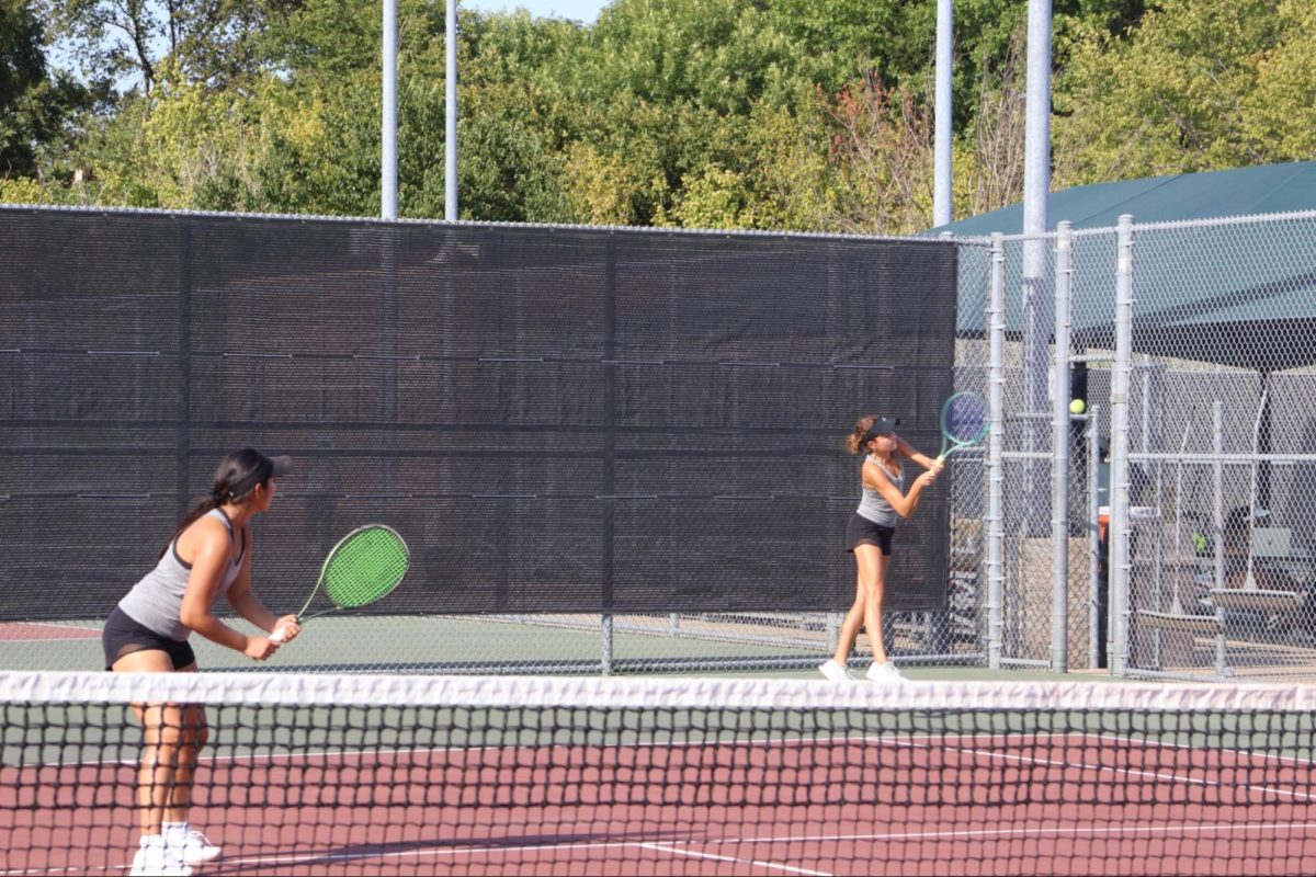 Coppell junior Lexie Patton takes a backhand in her girls doubles match alongside freshman partner Palkin Gangwal against Frisco Lebanon Trail’s Addison Rosser and junior Maika Wendt. The Cowboys lost to the Trail Blazers, 11-9, on Friday at the CHS Tennis Center. Photo by Sabah Uddin.