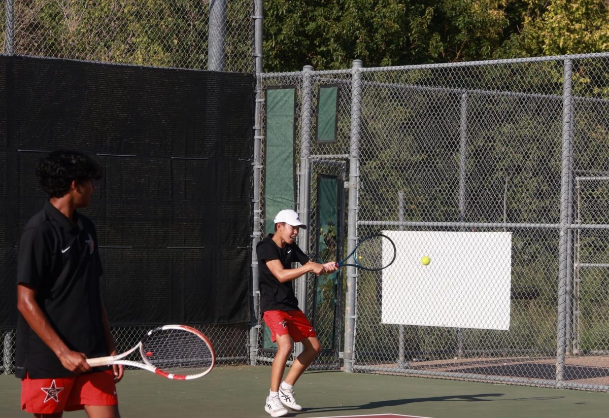 Coppell freshman Leyton Wang returns during a doubles match with Coppell senior Aneesh Thummala against Denton Braswell on Tuesday at the Coppell Tennis Center. Coppell remained undefeated throughout the tournament against Braswell, 19-0.