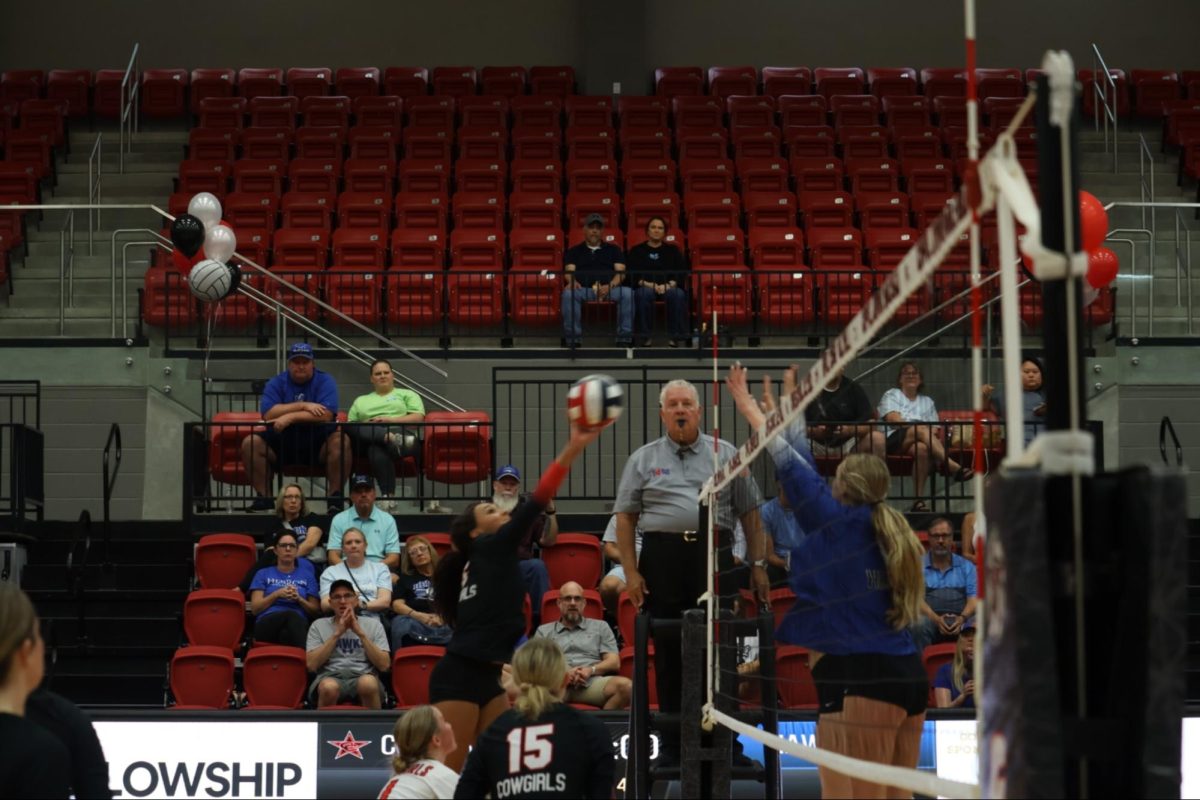 Coppell junior opposite hitter Mari Hill tips against Hebron on Friday at CHS arena. The Cowgirls lost to Hebron, 3-0 (25-7, 25-13, 25-15). Photo by Raima Awan
