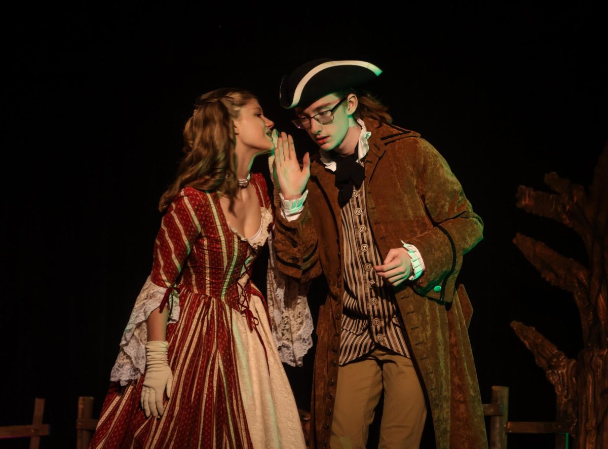 CHS9 actors Clarie McSpaden and Dee Raibourn, as Katrina Van Tassel and Ichabod Crane,  exchange a secret at the Halloween frolic during the dress rehearsal of “The Legend of Sleepy Hollow on Oct. 23. The CHS9 theater company’s fall show “The Legend of Sleepy Hollow” ran Thursday, Friday and Saturday in the CHS9 Dome.  


  
