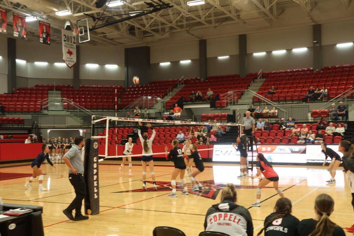 Coppell sophomore middle blocker Finley Penniman blocks against Flower Mound in CHS Arena on Friday. The Cowgirls lost 25-22, 25-21, 26-24, to the Jaguars.