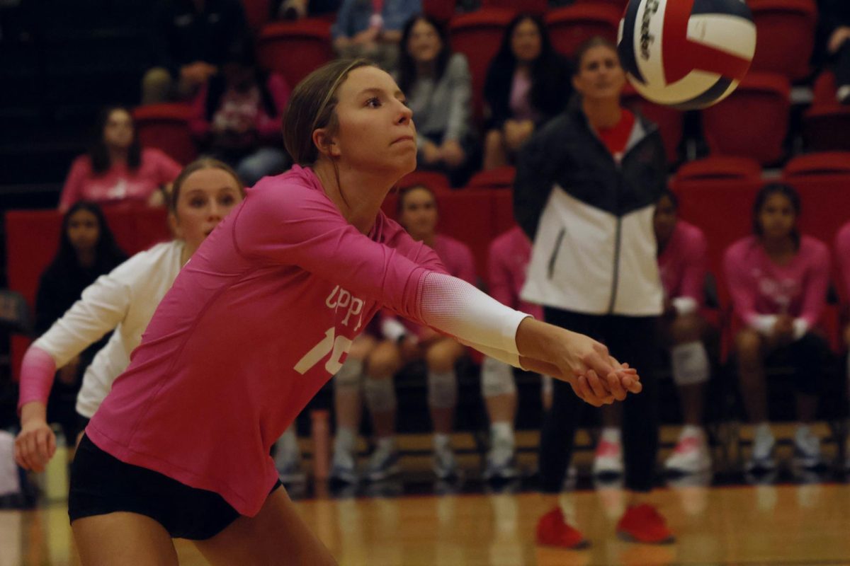 Coppell sophomore outside hitter Brooke Felix digs against Lewisville on Friday at CHS Arena. The Cowgirls defeated the Farmers, 25-13, 22-25, 25-20, 25-17.