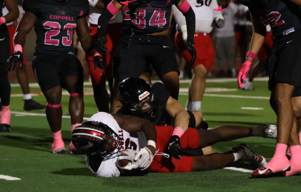 Coppell senior safety Matthew Neitzel tackles Denton Braswell senior running back Brailyn Strickland on Friday night at Buddy Echols Field. The Cowboys defeated Braswell, 53-0, to secure a playoff berth.