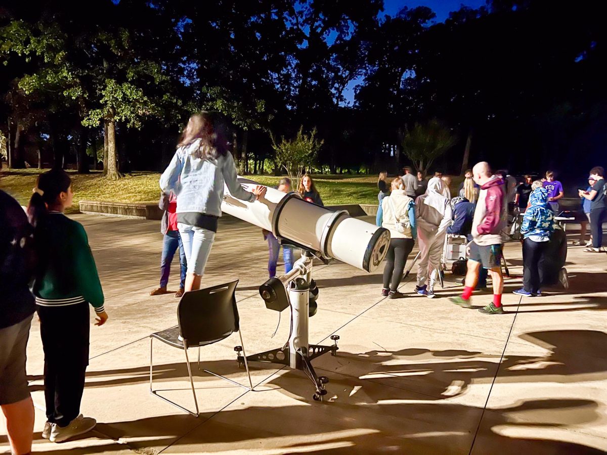 Attendees of the Astro Party observe the night sky through telescopes provided by Coppell High School’s Astronomy class. The CHS Astronomy class held its annual Astro Party at CHS on Oct. 16 to showcase their knowledge and view the sky through telescopes. Photo by Prisha Hooda