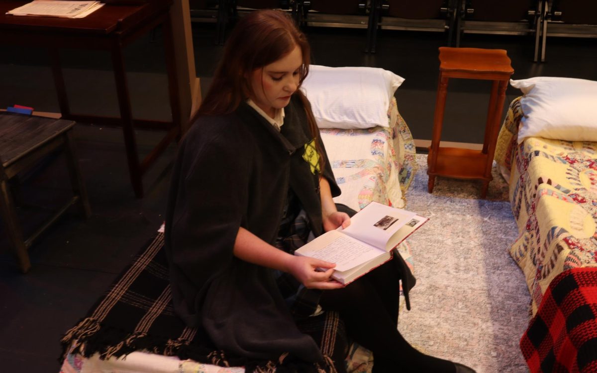 Sarah Villaret-Dean, playing Anne Frank, reads her diary in her room in “The Diary of Anne Frank” on Oct. 6. Theatre Coppell’s production of “ The Diary of Anne Frank” ran at the Coppell Arts Center from Sept. 20-Oct. 6.