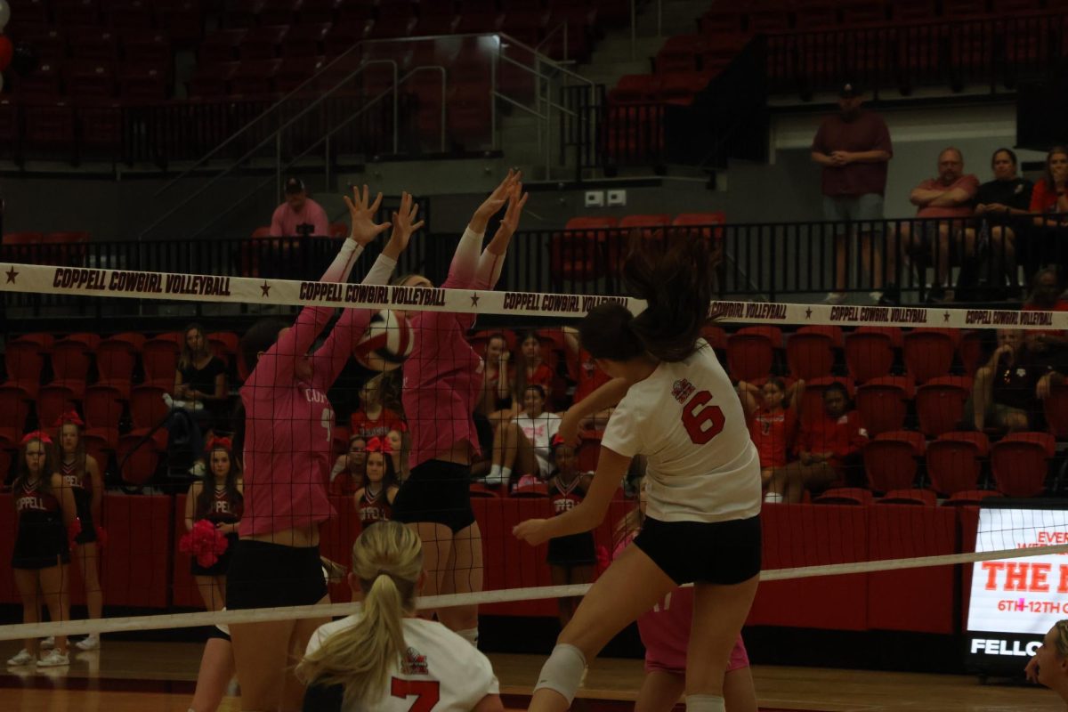 Coppell senior Carolina Ufret and sophomore Brooke Felix block against Marcus on Friday at CHS Arena. The Marauders defeated the Cowgirls, 16-25, 18-25, 25-20, 20-25. Photo by Greeshma Marathu