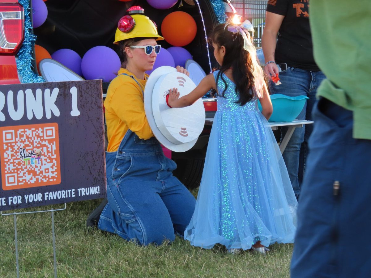 Volunteers hand out candy to children at the Flick or Treat event at Andrew Brown Park. The City of Coppell hosted Flick or Treat on Oct. 19 where children and families gathered for a Halloween celebration. 
