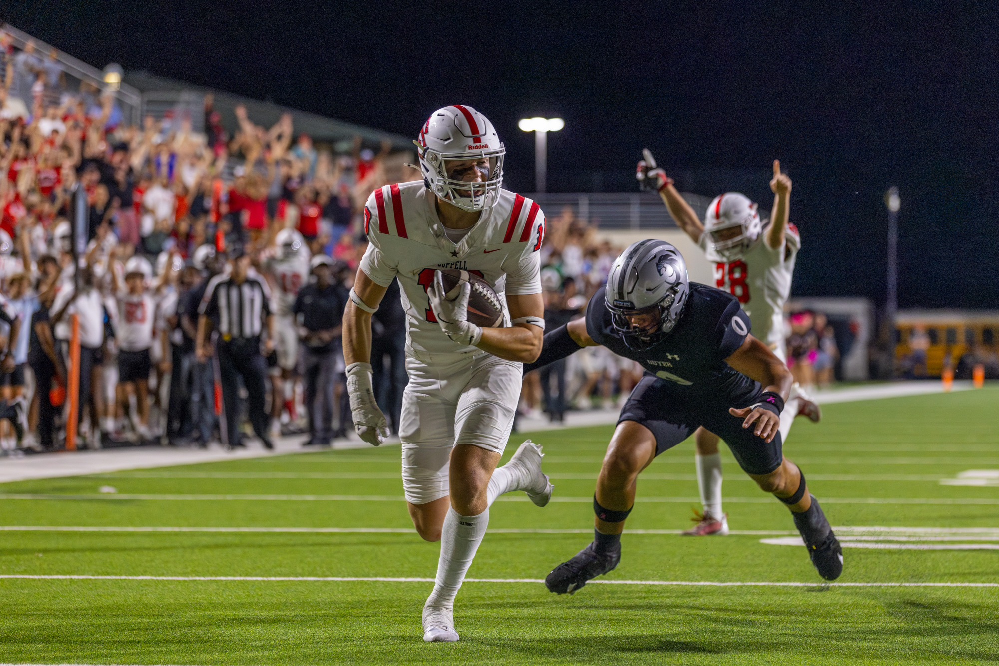 Coppell senior safety Alex Kraus evades Denton Guyer sophomore tight end Zane Rowe and scores a touchdown off of an interception at C.H. Collins Athletic Complex on Friday. The Cowboys defeated the Wildcats, 31-24, in a Class 6A top 20 showdown.