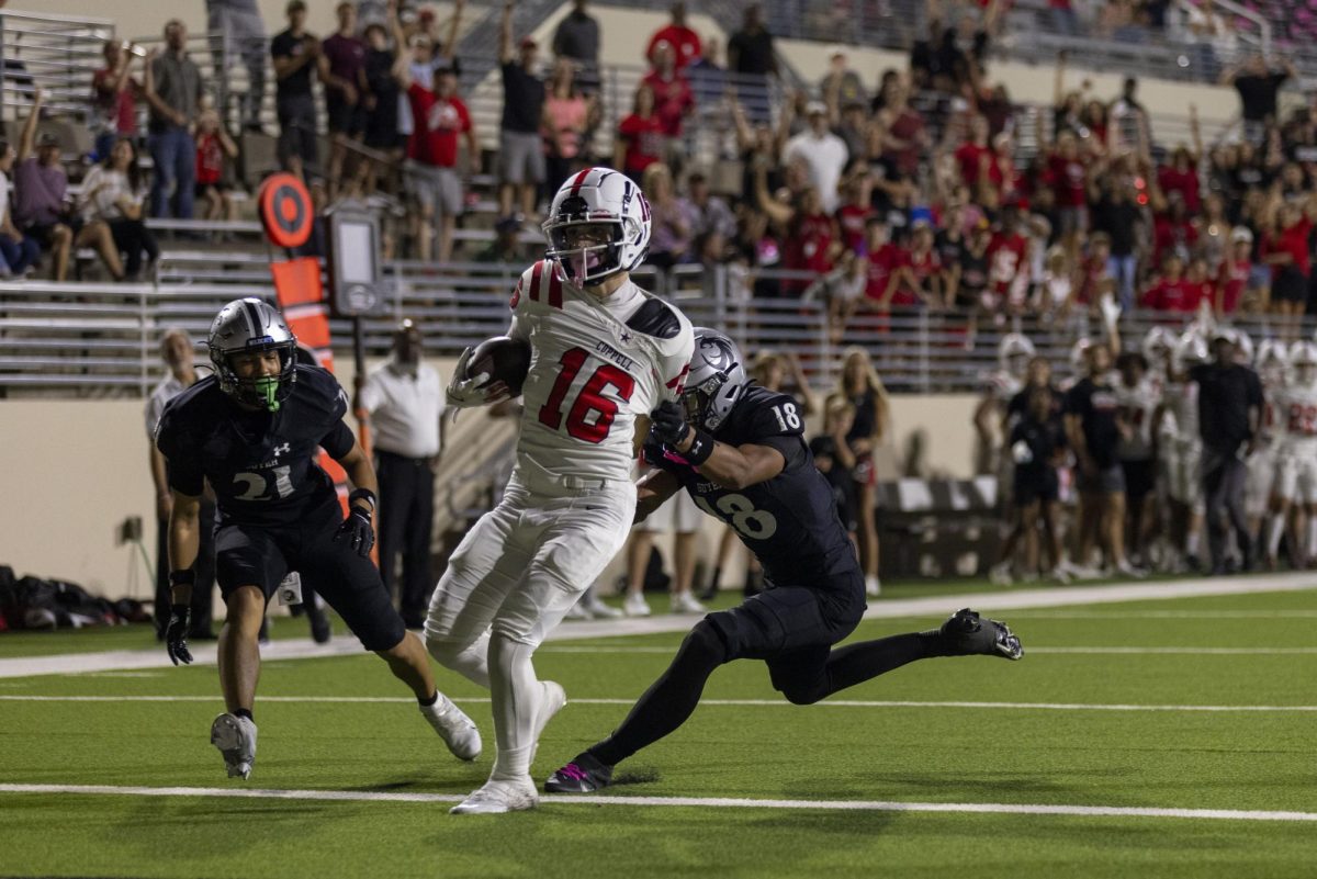 Coppell senior wide receiver Ethan Schuy breaks past Denton Guyer junior safety Jaylon Sterling for a touchdown at C.H. Collins Athletic Complex on Friday. The Cowboys defeated the Wildcats, 31-24.