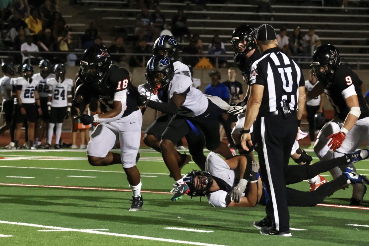 Coppell senior running back Josh Lock approaches the end zone as Hebron junior defensive back Kylan Smart tails him during the homecoming game at Buddy Echols Field on Sept. 27. The Cowboys defeated the Hawks, 49-14, in their first district game of the 2024-25 season. 