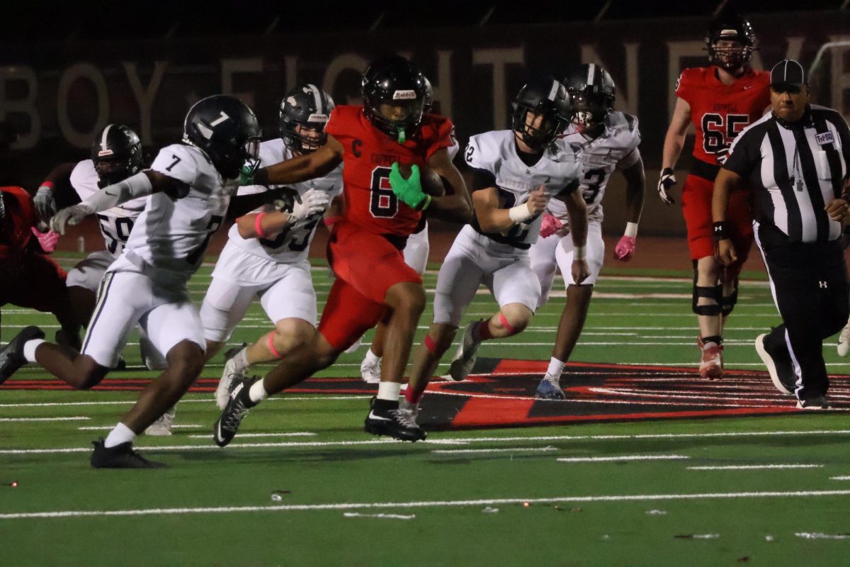 Coppell senior running back O’Marion Mbakwe rushes past Little Elm’s defensive line at Buddy Echols Field on Friday. The Cowboys defeated Little Elm, 59-14, to improve to 6-0 overall and 3-0 in District 5-6A.