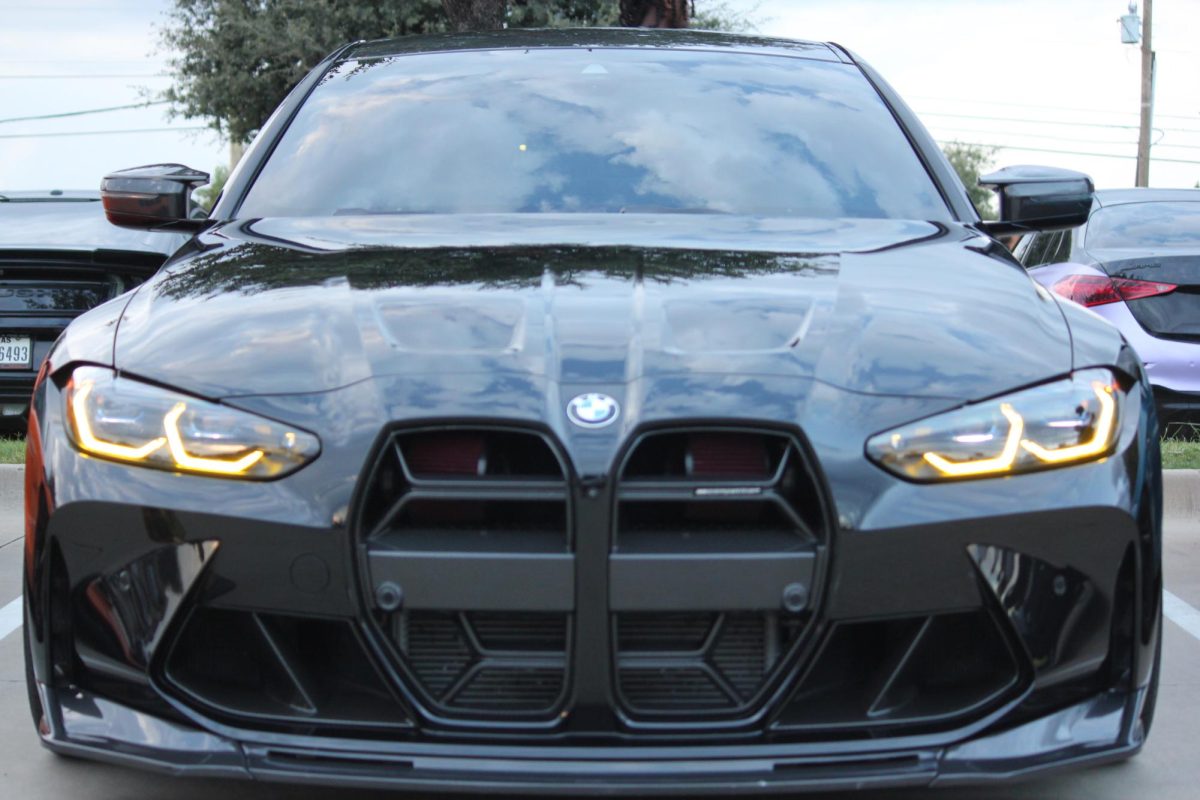 The 2023 BMW M4 Competition, a high-performance sports car, is parked outside Gypsy Lime Taco Lounge  in Irving on Sept. 22 during the Cars & Tacos car meet. Cars & Tacos is an event where car owners are welcome to register and display their car in a parking lot next to a selected taco restaurant. Photo by Maanav Subramanian.