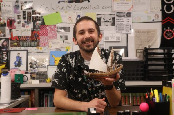 Coppell High School AP World History teacher Conner Blake holds an artifact that represents his classroom. Blake’s passion for teaching stems from his eighth grade U.S. History teacher as he hopes to make a difference in his students’ lives.