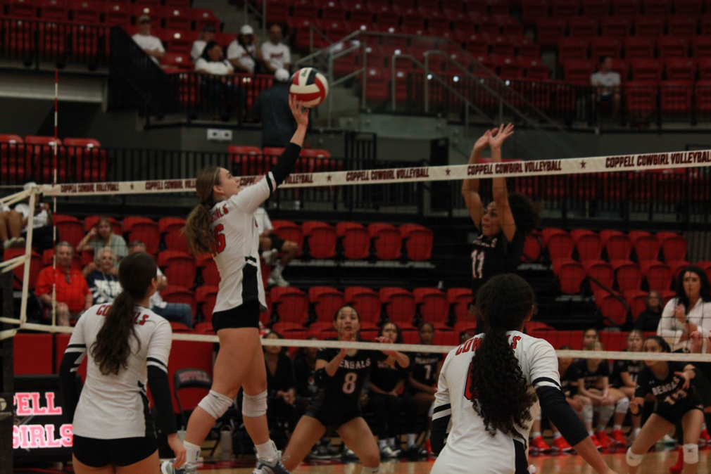 Coppell sophomore middle blocker Finley Penniman hits against Denton Braswell at the CHS Arena. The Cowgirls defeated the Bengals.