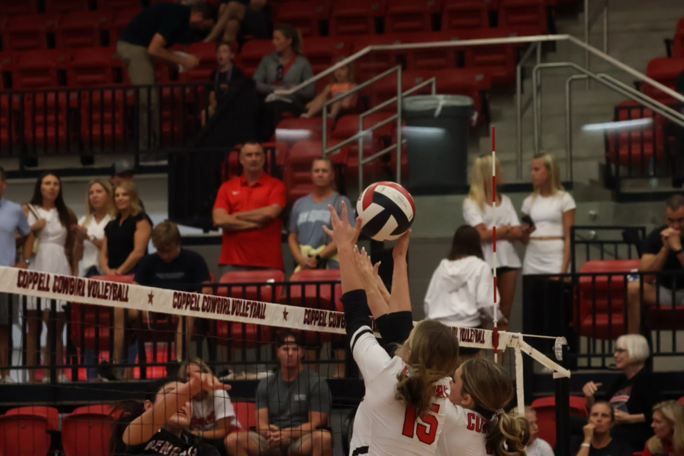 Coppell sophomore Sawyer Frosk and junior outside hitter Ryan Hoerman block against Denton Braswell on Friday at CHS Arena. The Cowgirls defeated the Bengals.