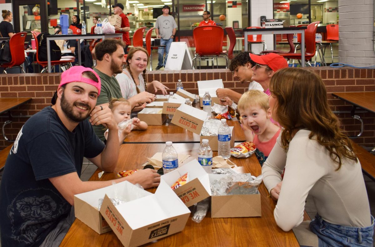 Families enjoy food catered from Dickey’s Barbecue Pit at the Coppell ISD Community Tailgate on Oct. 25. The community tailgate, which included Dickey's Barbecue, was held in the Coppell High School Commons prior to the football game against Denton Braswell. 
