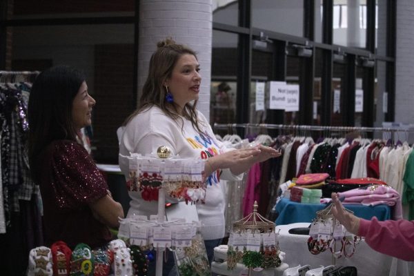 Striped Box Boutique owner converses with customers at the Holiday House fundraiser. Holiday House was open from 11 a.m. to 4 p.m. at Coppell High School, where local vendors sold products for the holiday season.