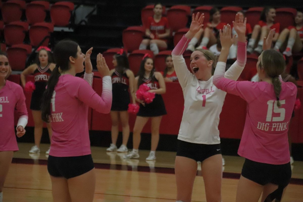 Coppell junior volleyball captain Molly Williams celebrates a successful play against Flower Mound Marcus on Oct. 14 at CHS Arena. Williams is a captain for the Cowgirls with more than eight years of volleyball experience.Photo by