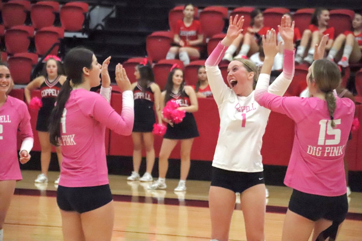 Coppell junior volleyball captain Molly Williams celebrates a successful play against Flower Mound Marcus on Oct. 14 at CHS Arena. Williams is a captain for the Cowgirls with more than eight years of volleyball experience. Photo By Naseeha Masood