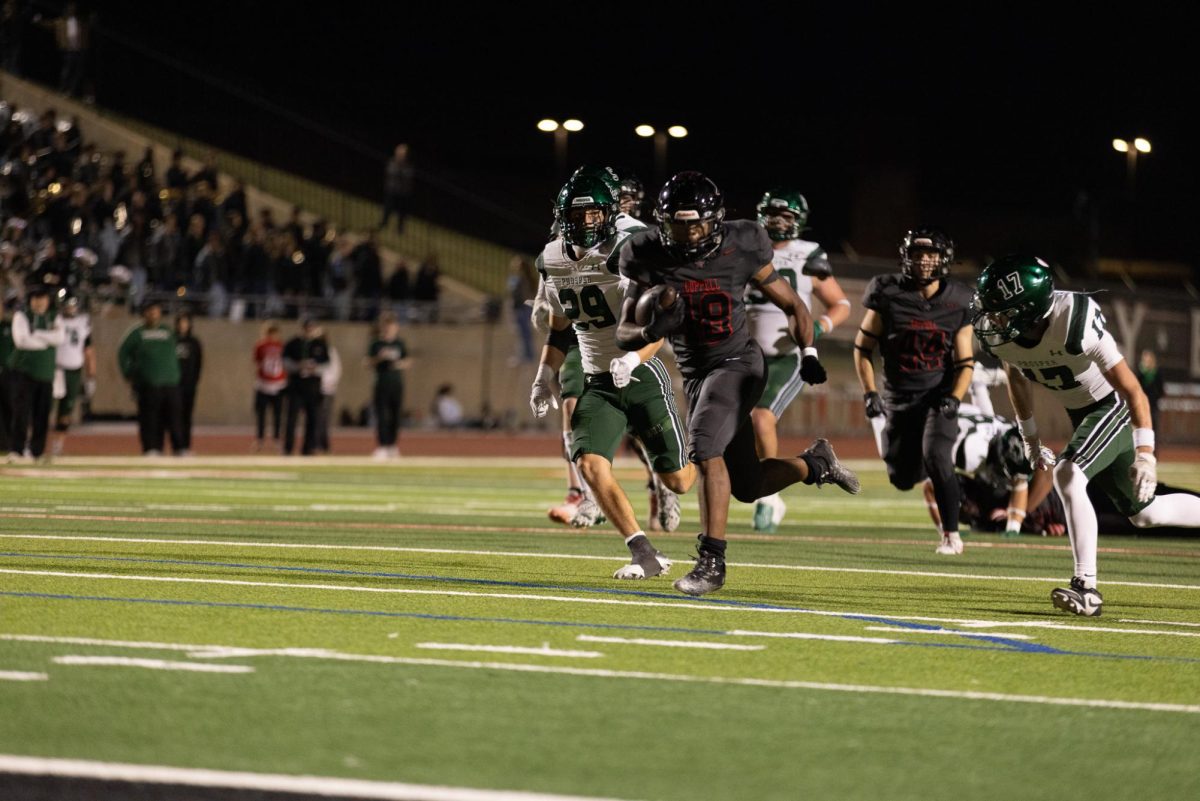 Coppell senior running back Joshua Lock outruns Prosper junior safety Logan Thompson and sophomore linebacker Fahd Allan to score a touchdown on Friday night at Buddy Echols Field. The Cowboys beat the Eagles 35-27. Photo by Kayla Nguyen