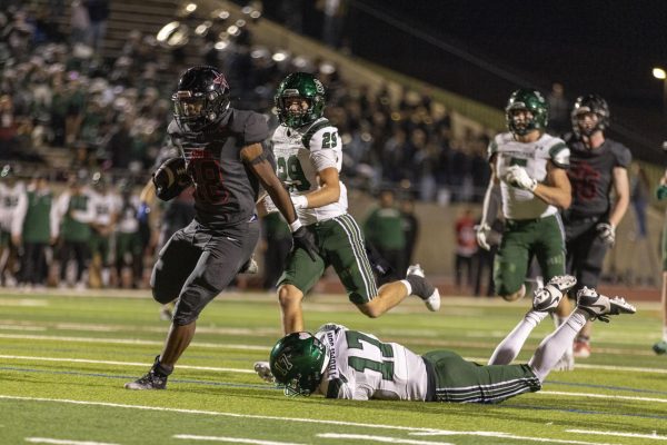 Coppell senior running back Josh Lock evades the Prosper defense to score a touchdown at Buddy Echols Field on Friday. The Cowboys defeated the Eagles in the Class 6A Division I Region I bi-district Playoffs, 35-27.